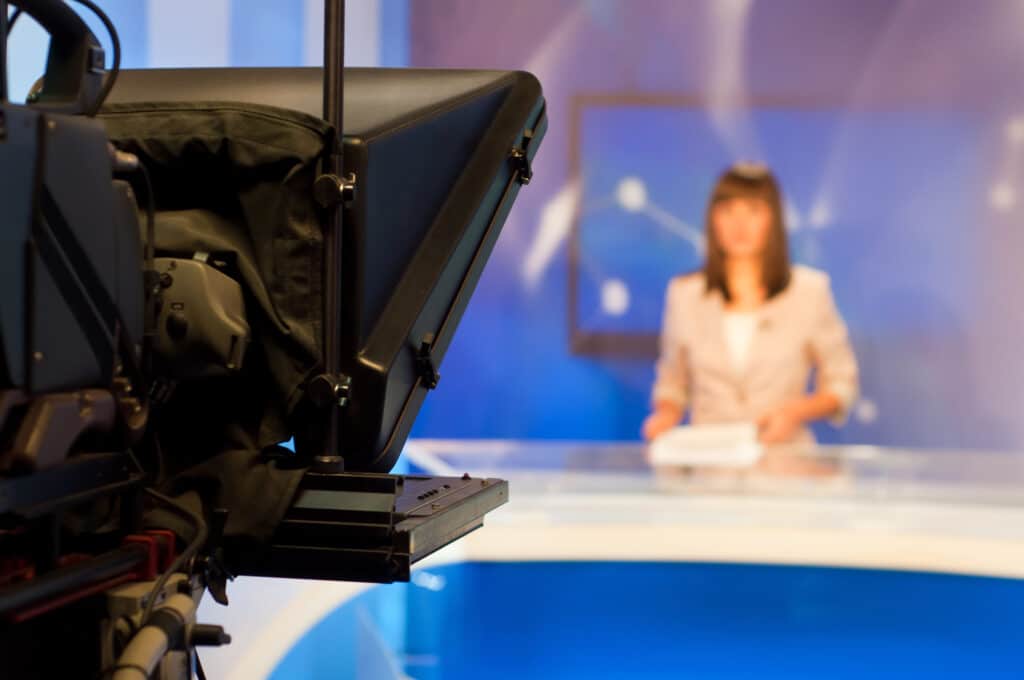 Female reporter presenting news in TV studio