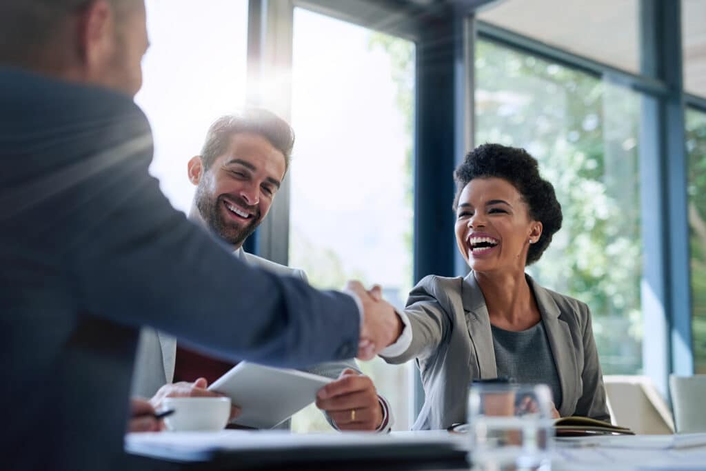 business people shaking hands in the office for a deal