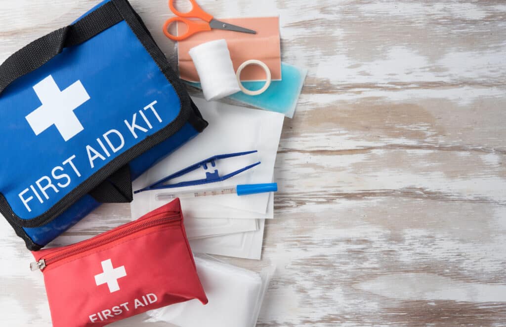 First aid medical kit on wood background