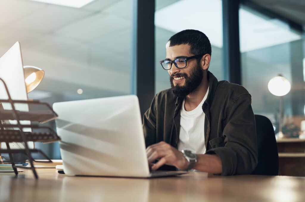 Businessman with a laptop working on emails or reviewing ticket sales